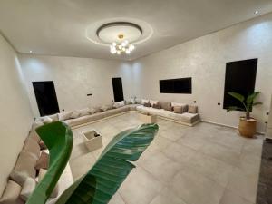 a large living room with a couch and a plant at Luxury Villa Lam atlas view in Marrakesh
