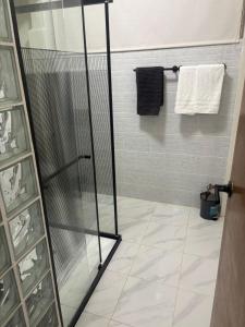 a shower with a glass door in a bathroom at Bello Departamento Completo con 2 recámaras! in San Baltasar