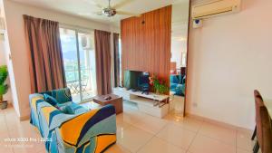 a living room with a couch and a television at Mansion One by Hejmo Suites in George Town