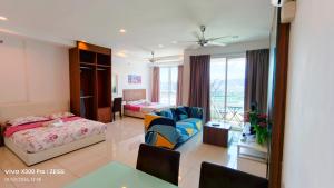 a hotel room with a bedroom and a living room at Mansion One by Hejmo Suites in George Town