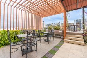 a patio with tables and chairs on a roof at Hotel Boutique ADAZ in Santa Marta