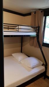 a bunk bed with two white pillows in a room at Casa Prunelli in Bastelicaccia