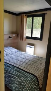 a bedroom with a bed and a window at Casa Prunelli in Bastelicaccia