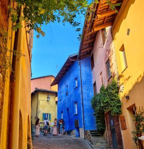 a group of people walking down a street in an alley at La Blu di Via Silvano 8 in Monforte dʼAlba