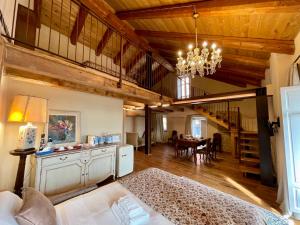 a living room with a bed and a dining room at La Blu di Via Silvano 8 in Monforte dʼAlba