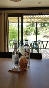 a table with two bottles of alcohol and a sandwich at Casa Prunelli in Bastelicaccia