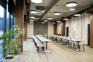 a row of tables and chairs in a room with windows at Dili Town Resort and Spa in Dilijan +115 photos