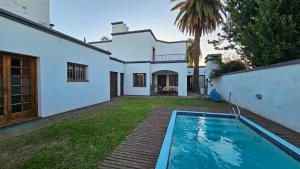 an exterior view of a house with a swimming pool at Casona El Rosedal in Bell Ville