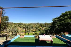 a view of the pool from the balcony of a resort at Rudrakshi Inn in Mount Ābu