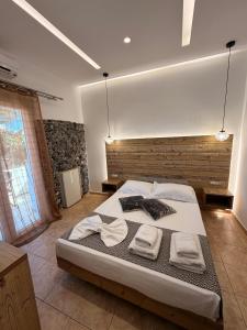 a bedroom with a large bed with towels on it at Villa Livadaros in Karterados