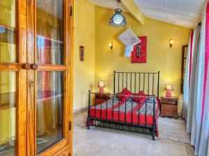 a bedroom with a bed with red pillows on it at Résidence Soros - Île de Gorée in Dakar