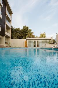 a large swimming pool in front of a building at The View Luxor hotel in Luxor