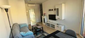 a living room with a couch and a tv at Casa Dolores in Puerto de Mazarrón