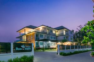 a large house with a fence in front of it at Baan I Inspire in Phrae
