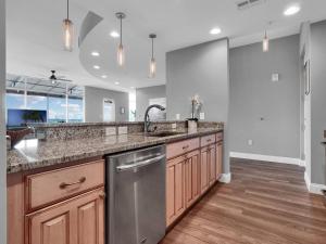 a large kitchen with a sink and a dishwasher at Luxurious Penthouse with large patio in Orlando