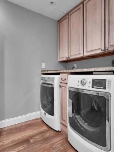 a kitchen with a washing machine and a dishwasher at Luxurious Penthouse with large patio in Orlando