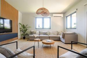 a living room with a couch and a table at Spacious House with Pool and BBQ in Arenales