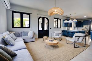 a living room with a couch and a table at Spacious House with Pool and BBQ in Arenales