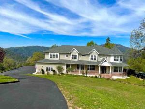 a large white house with a driveway at Blue Stone Chateau Yosemite Pool Spa Secluded in Abbeyville