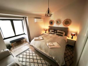 a bedroom with a bed with two towels on it at Duplex Apartman with sunny terrace in Mijas Pueblo in Mijas