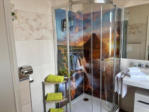 a bathroom with a shower with a painting on the wall at Hotel Berlin in Leipzig +62 photos