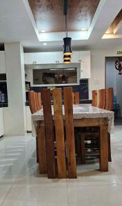 a kitchen with a wooden table and chairs at MEEK'S VILLAS TRANSIENT HOUSE in Baguio +19 photos