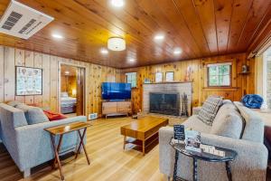a living room with a couch and a fireplace at Eagle Beach Retreat in Freeland