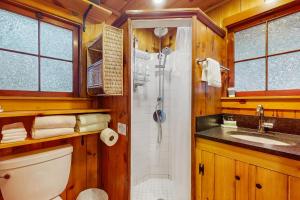 a bathroom with a shower and a toilet and a sink at Eagle Beach Retreat in Freeland +18 photos