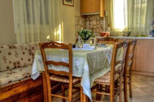 a kitchen with a table with chairs and a couch at Mainades Maisonettes & Studios - Andros Serene Escape in Ménites +37 photos
