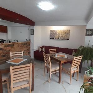 a living room with a table and chairs and a couch at Apartments Villa Saray in Ohrid