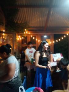 a woman in a blue dress standing in a room at Kactus de la abuela in Yerba Buena +25 photos