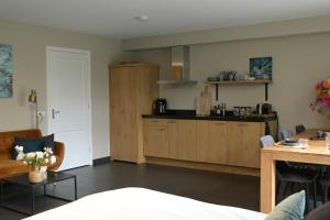 a living room with a kitchen and a table at B & B Meet the Dutch in Ridderkerk