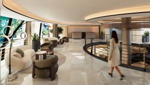 a woman walking through a lobby in a building at Senator Banus Adults Only Recommended in Estepona