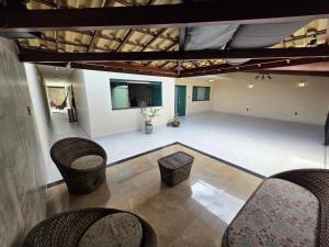 an empty living room with chairs and a table at Inocoop house in Camaçari