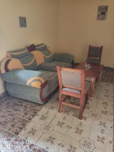 a living room with a couch and a chair at Kizi Villas in Watamu