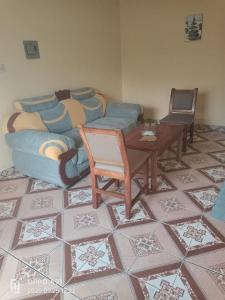 a living room with a couch and a table at Kizi Villas in Watamu +1 photo
