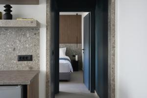 a room with a bed and a door leading to a bedroom at Opulence12 Suites in Karpathos +113 photos
