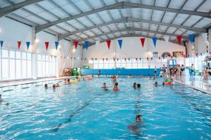 a group of people in a swimming pool at Unity Beach in Berrow