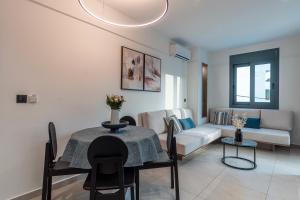 a living room with a table and a couch at Opulence12 Suites in Karpathos