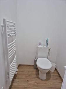 a bathroom with a white toilet in a room at le St fursy 31 in Péronne +27 photos