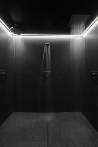 a dark room with a urinal and lights on the wall at Mauritius Hotel & Therme in Cologne