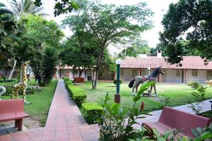a park with a statue of a horse in the grass at Hotel Serrano Martins in Martins