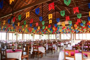 a banquet hall with tables and chairs and flags at Hotel Serrano Martins in Martins