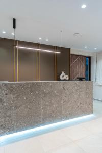 a lobby with a granite counter top in a building at Opulence12 Suites in Karpathos