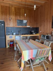 a kitchen with a table with a colorful blanket on it at Les Foucauds in Saint-Quentin-de-Caplong