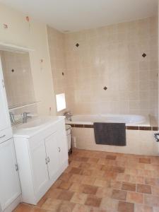 a bathroom with a sink and a bath tub at Gaëtan in Lainsecq +11 photos