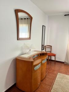 a bathroom with a vanity with a mirror on the wall at Meu Quintal 1, Calheta-Madeira in Calheta