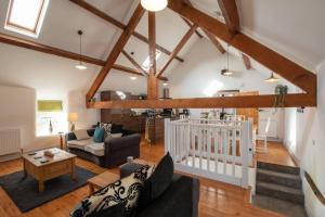 a living room with a couch and a crib at Bryn Lon in Caeʼr-geiliog