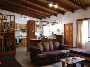 a living room with a couch and a kitchen at Wild Eden Self-Catering Accommodation in Swakopmund