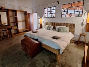 a bedroom with a large bed and a window at Wild Eden Self-Catering Accommodation in Swakopmund